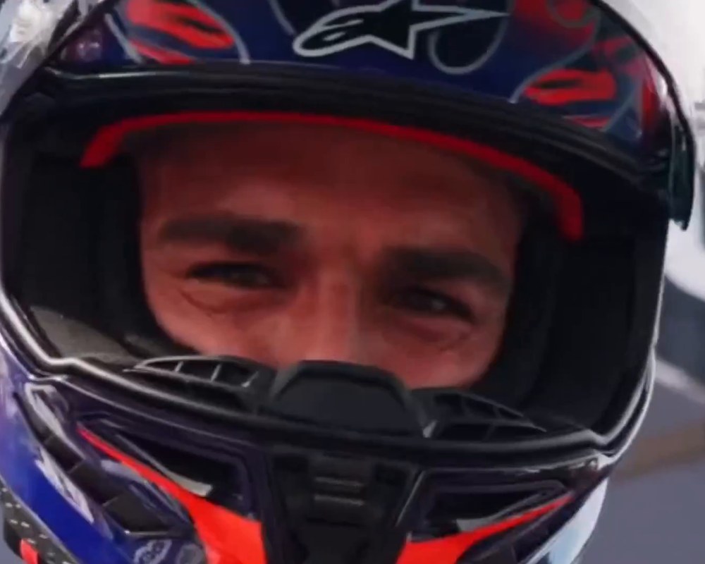 Cameron Petersen smiling behind his motorcycle race helmet